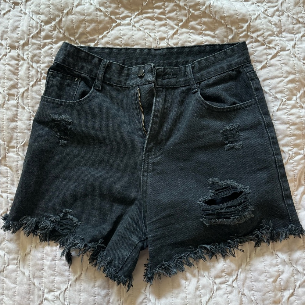 SHEIN distressed black denim shorts.